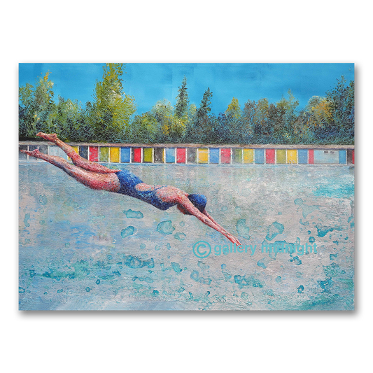 Swimmer in a blue costume diving into Tooting Bec Lido, colourful changing cabins and trees behind under a bright blue sky