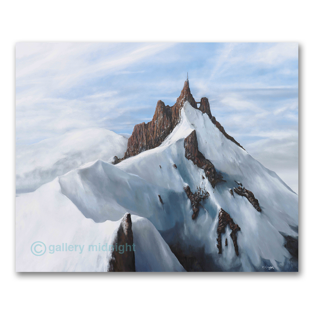 Mountain peak with snow and rocky terrain against a blue sky, featuring 'gallery midnight' branding.