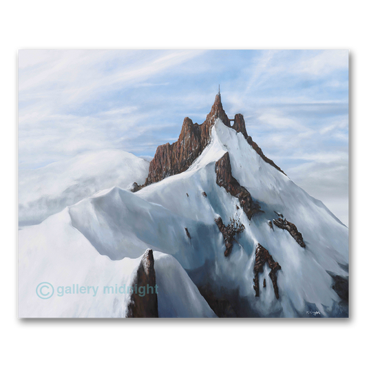 Mountain peak with snow and rocky terrain against a blue sky, featuring 'gallery midnight' branding.