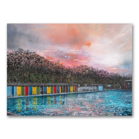 Limited edition art print of Tooting Bec Lido at sunrise with colourful changing cabins reflected in the water