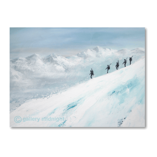 Five skiers walking along a narrow snowy ridge with skis on their backs, silhouetted against misty alpine mountains.